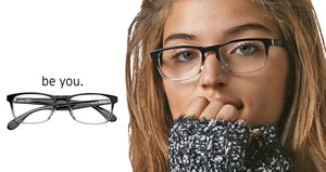A woman wearing hand-polished acetate, progressive reading glasses with a key-hole bridge and metal spring hinges. A close-up of the glasses is also shown.